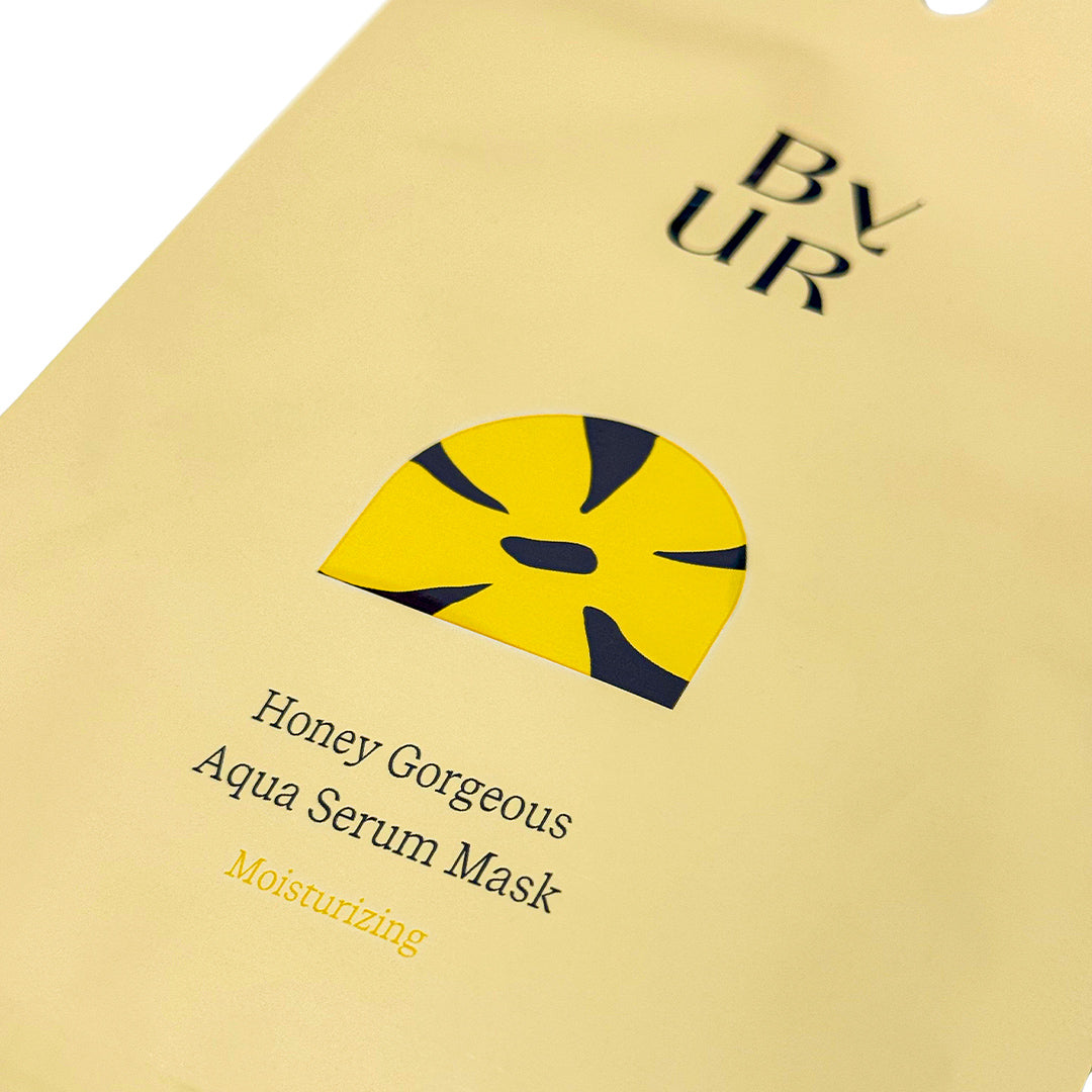 Close-up of a yellow BYUR sheet mask packaging with text and branding.