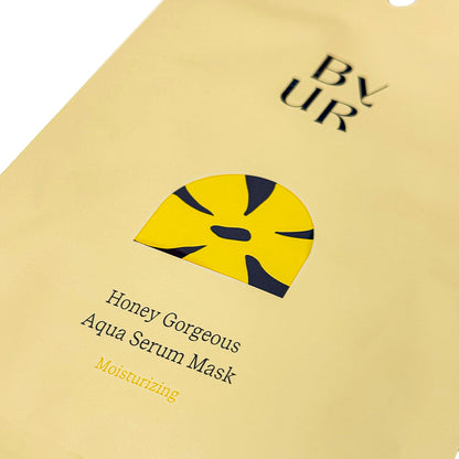 Close-up of a yellow BYUR sheet mask packaging with text and branding.